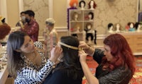 a group of women are getting their hair done in a salon